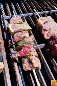 Portuguese beef skewers cooking on the grill