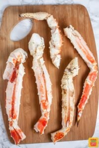 King crab legs on a wooden cutting board