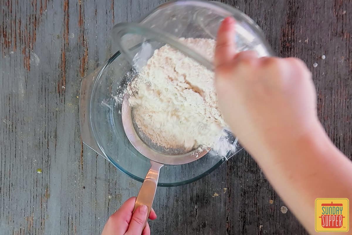 Sifting the flour to make Instant Pot Banana Bread