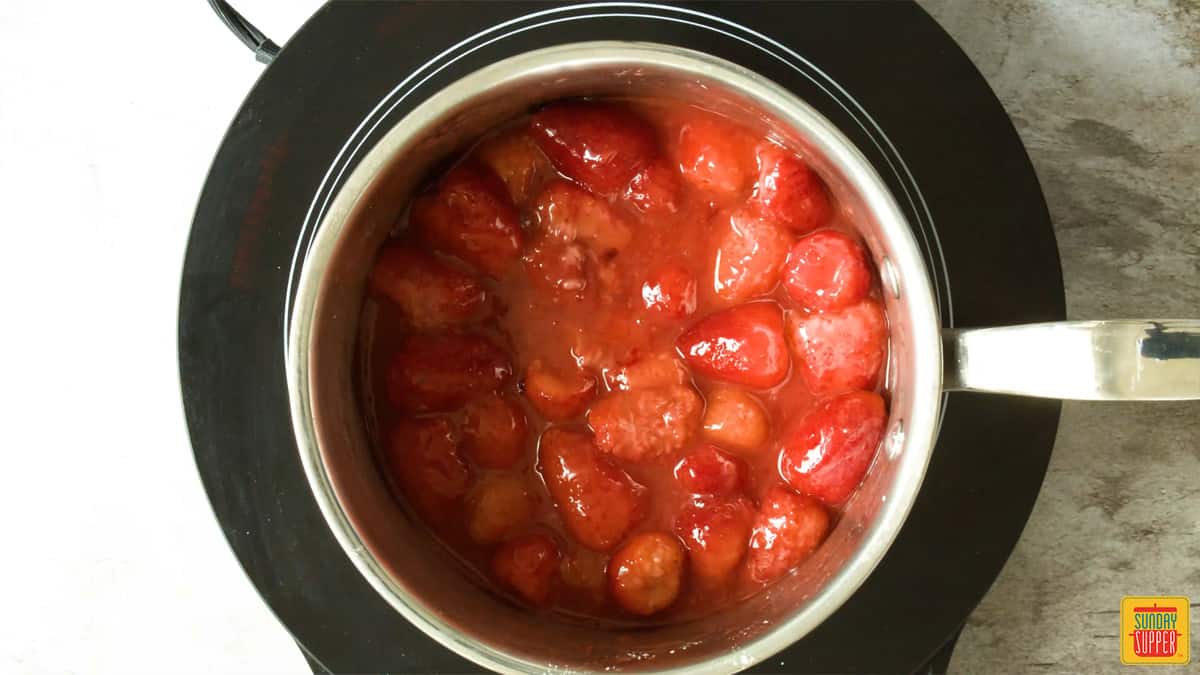 Strawberries cooked down in a sauce pan