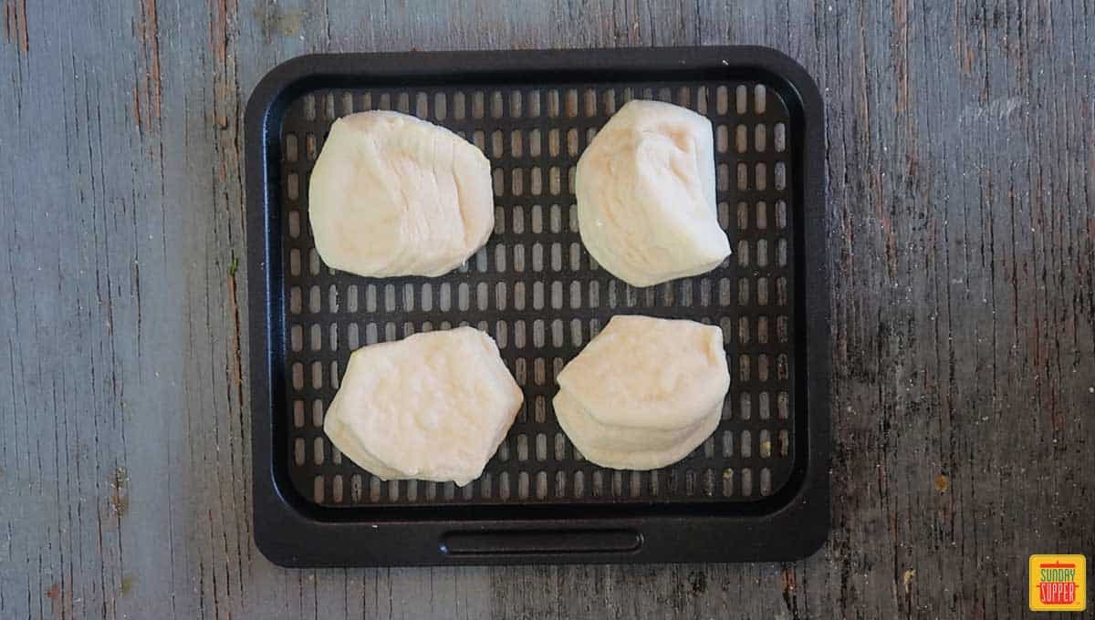 4 air fryer biscuits on a tray