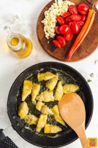 Cooking artichoke hearts in a skillet with olive oil