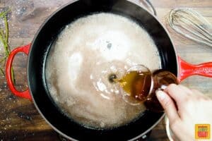 Pouring stock into au jus pan