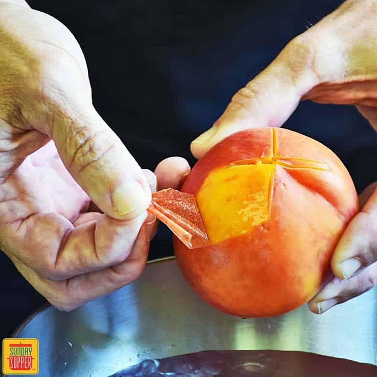 Using fingers to peel the skin off of a peach easily