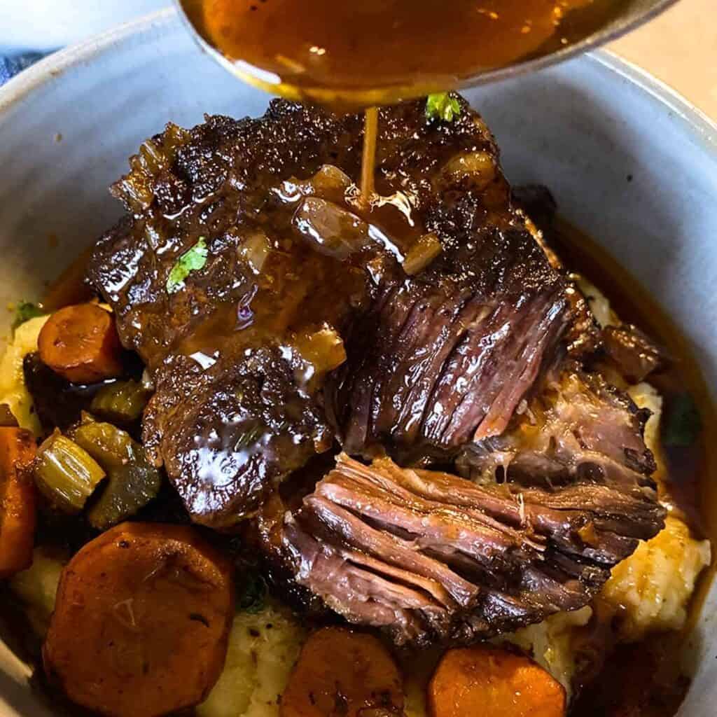 Slow cooker short ribs served over vegetables