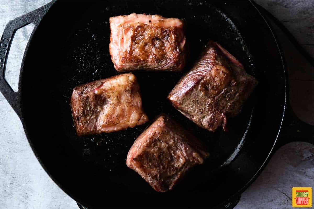 Searing ribs in a cast-iron skillet
