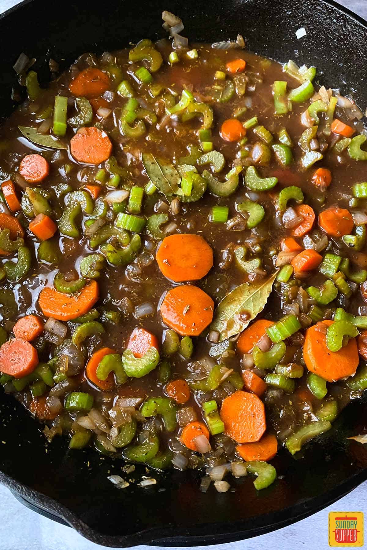 Vegetables simmering in cast iron skillet