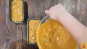 Pouring pumpkin loaf batter into baking pans