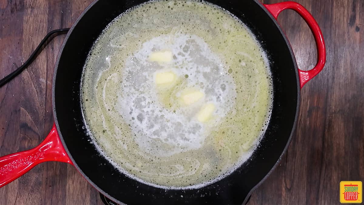 Lemon butter sauce cooking in a skillet