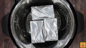 Three mini loaf pans in an instant pot covered with foil