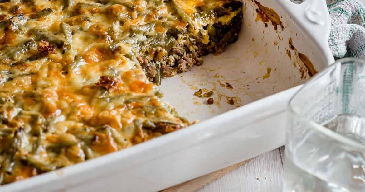 White casserole dish with keto cheeseburger casserole, missing a serving