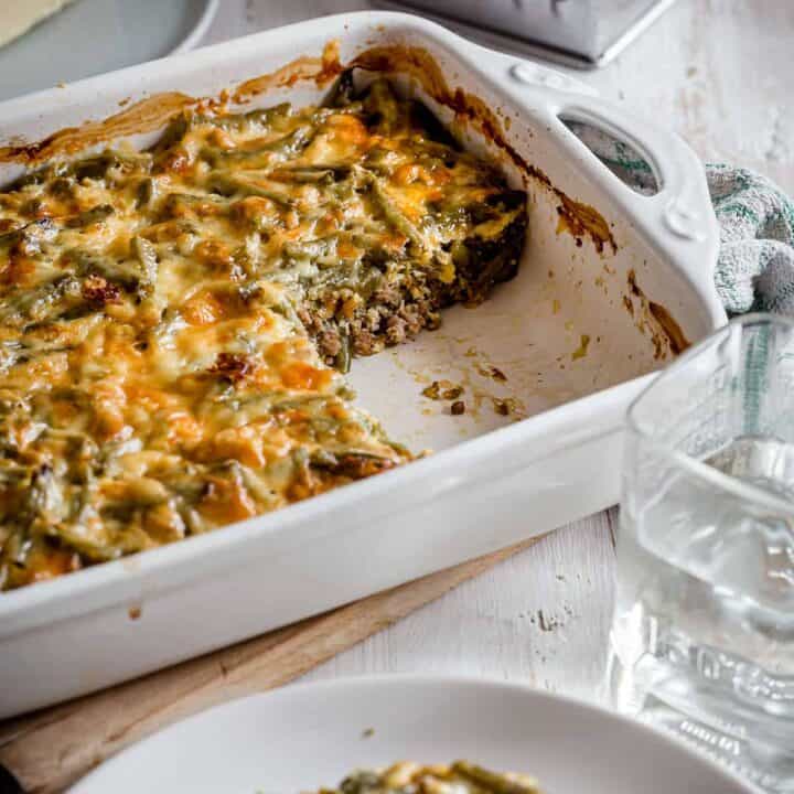 White casserole dish with keto cheeseburger casserole, missing a serving