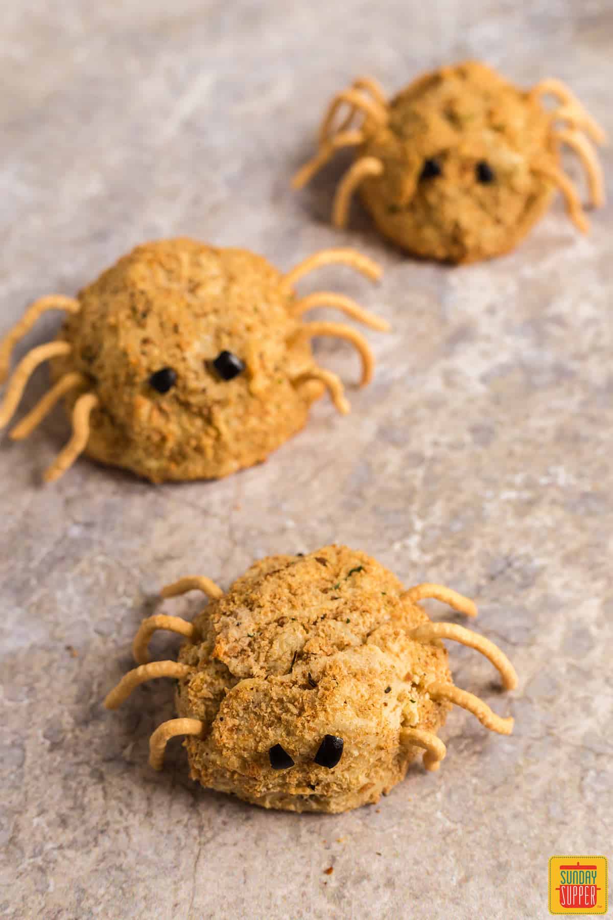 Three papas rellenas formed to look like cute spiders for Halloween