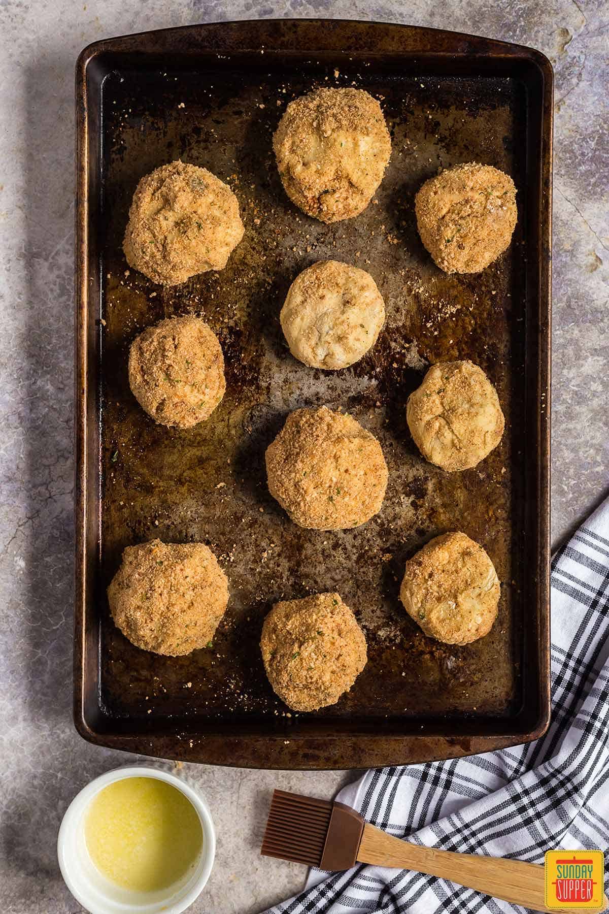 Stuffed potato balls on a baking sheet