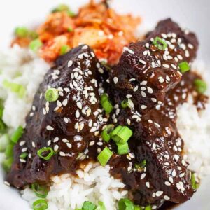 Korean braised short ribs (Galbi Jjim) over a bed of rice and kimchi