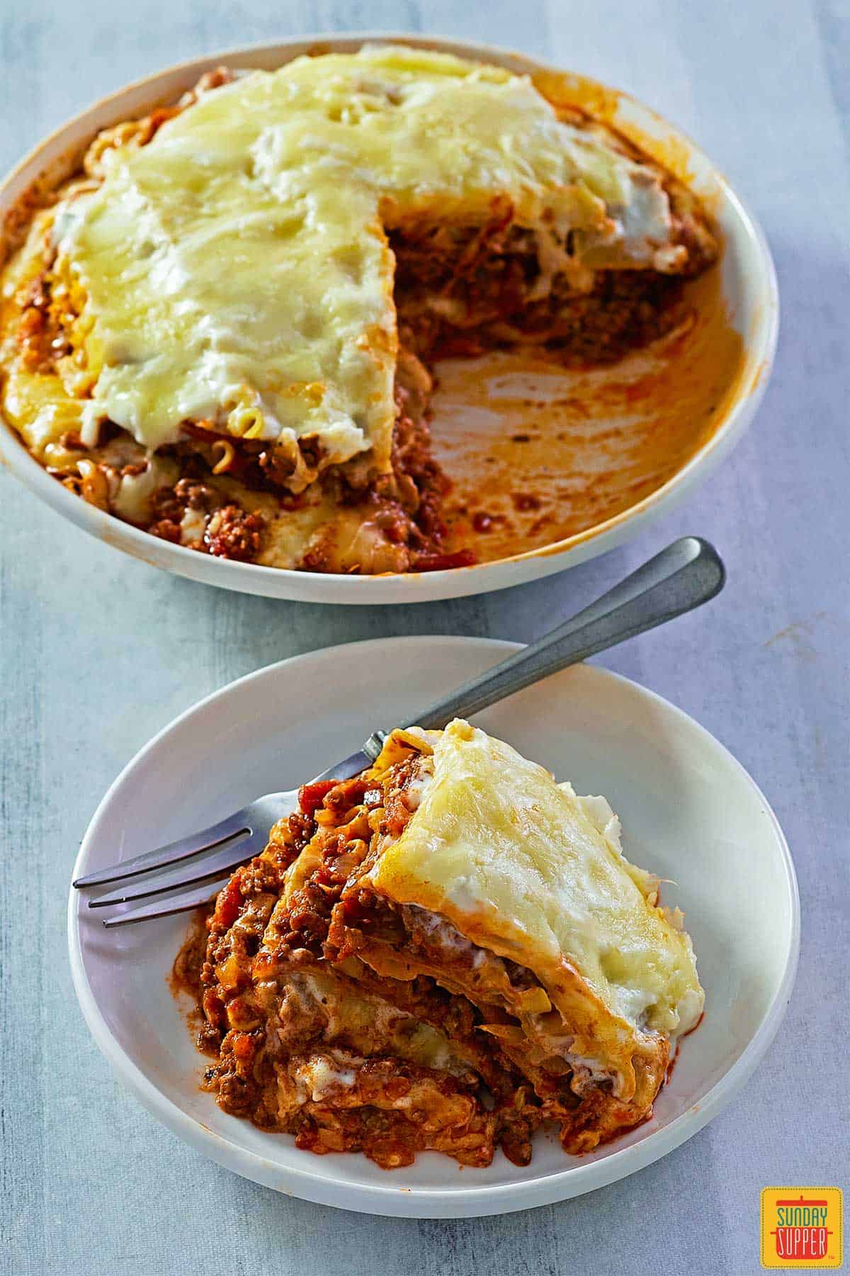 instant pot lasagna served on a plate next to dish of lasagna
