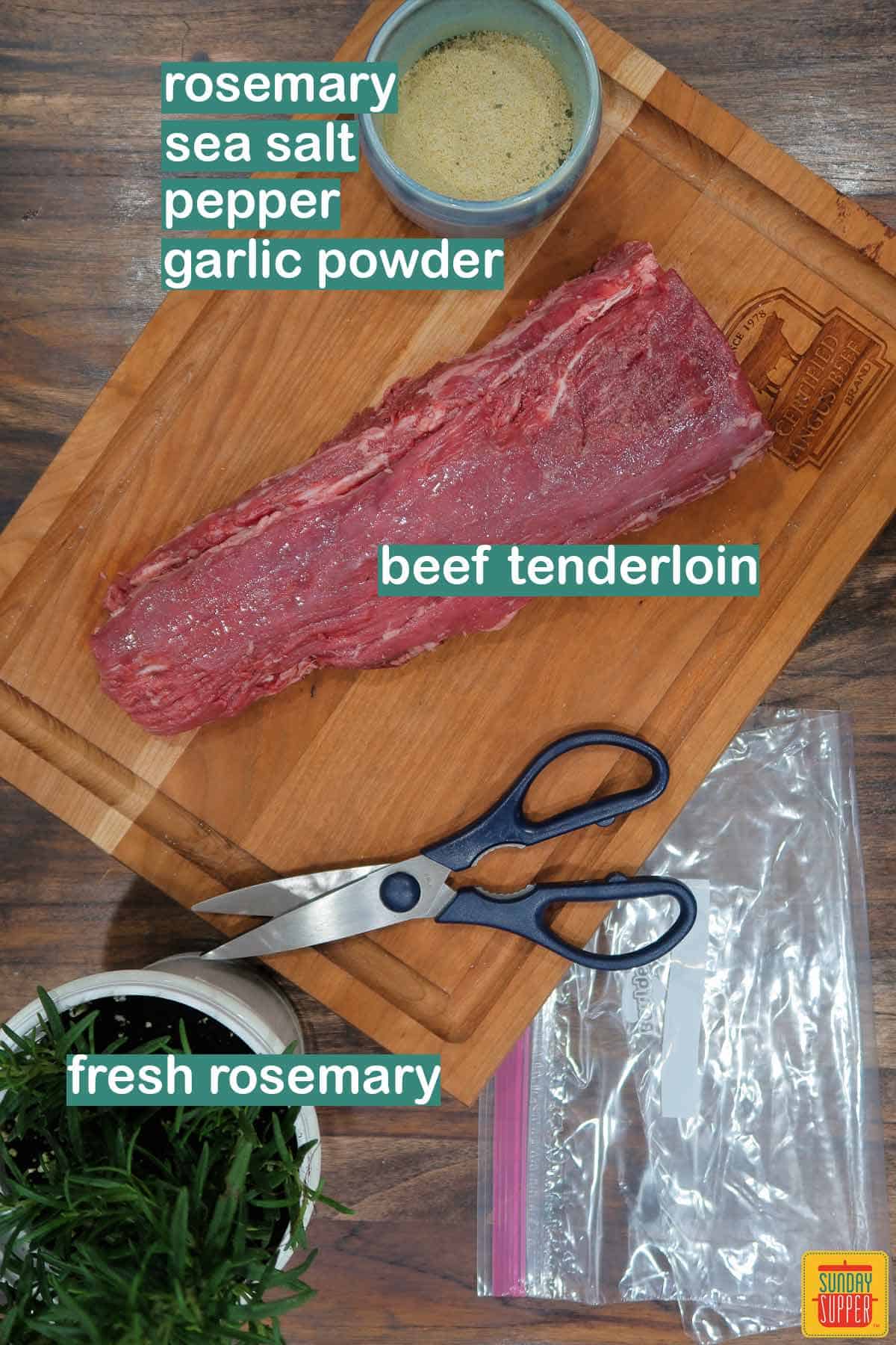 Ingredients to make sous vide beef tenderloin labeled on a table with scissors and plastic bags