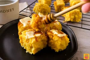 drizzling honey on top of cornbread with pats of butter