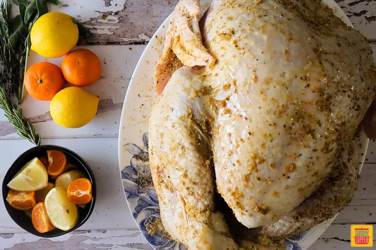 Uncooked turkey with seasoning spread on top