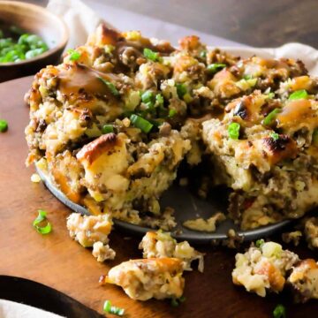 Instant pot sausage sage stuffing topped with parsley on a wooden board