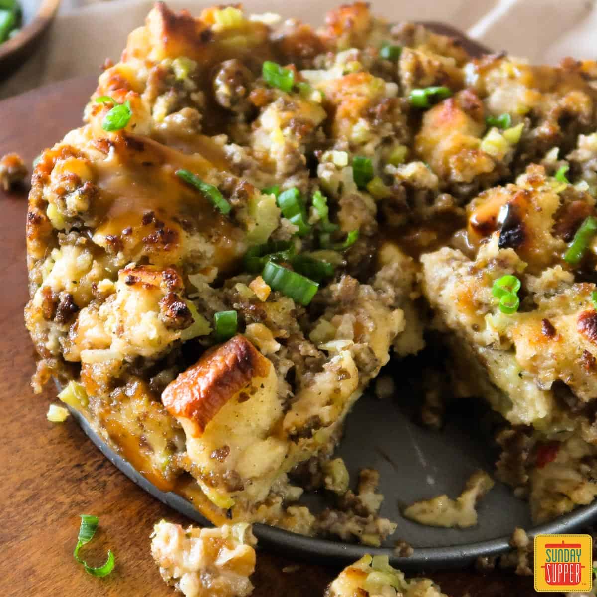 Instant pot sausage sage stuffing on a plate on a wooden board