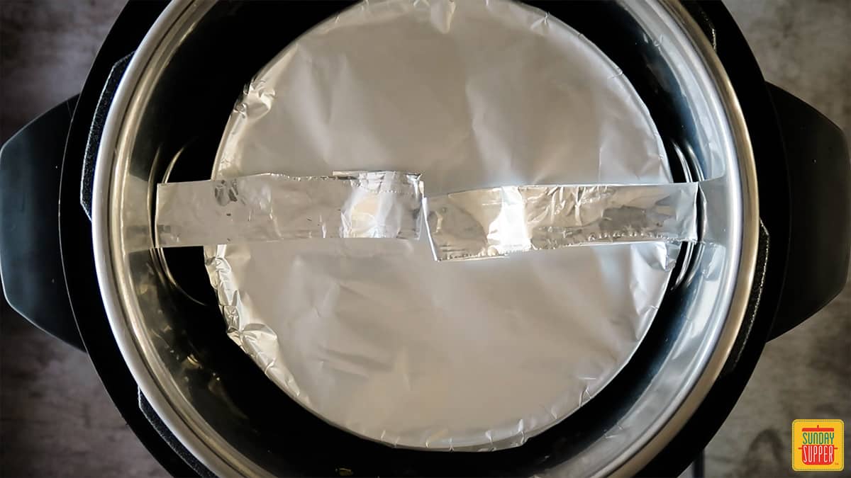 aluminum foil wrapped pan in the instant pot with a foil sling