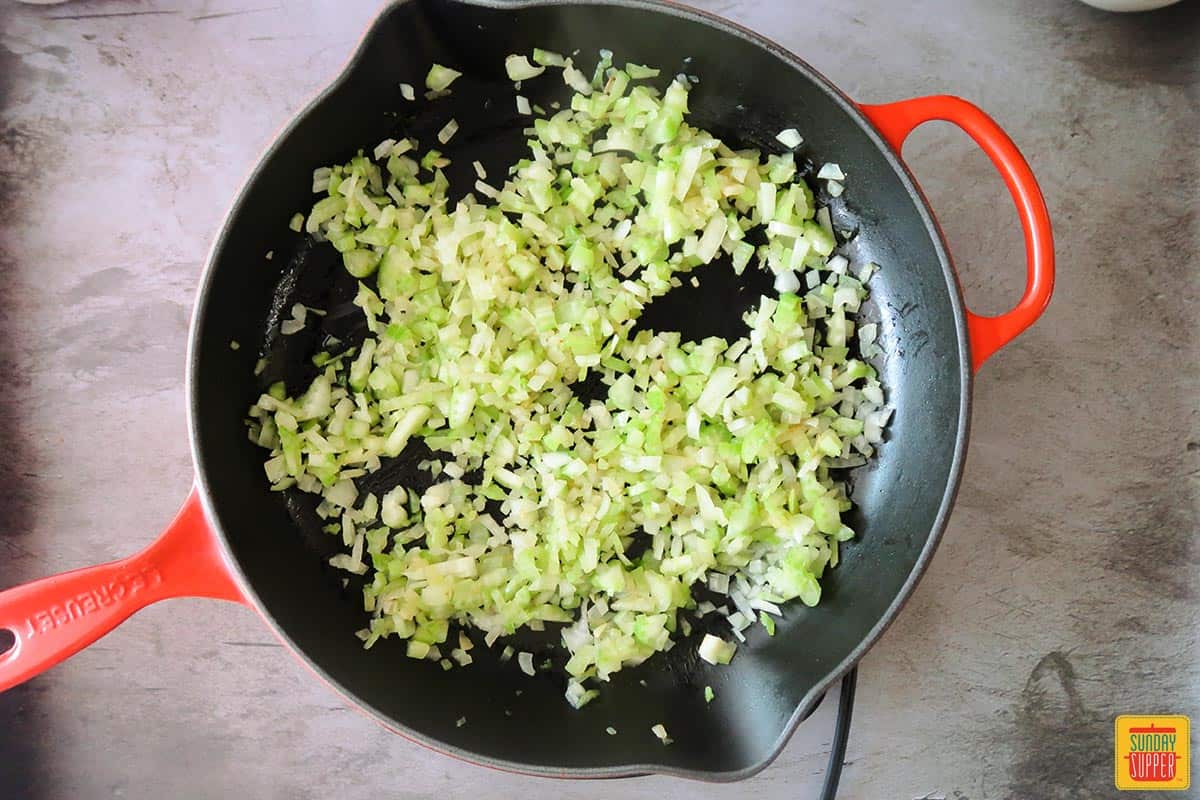 Onions and celery cooked down in a skillet