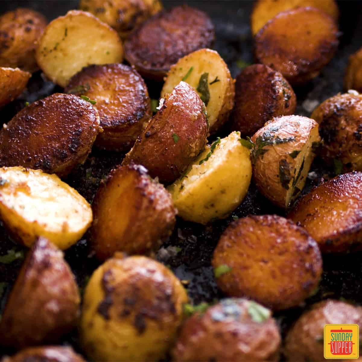 Close up of roasted potatoes in a skillet