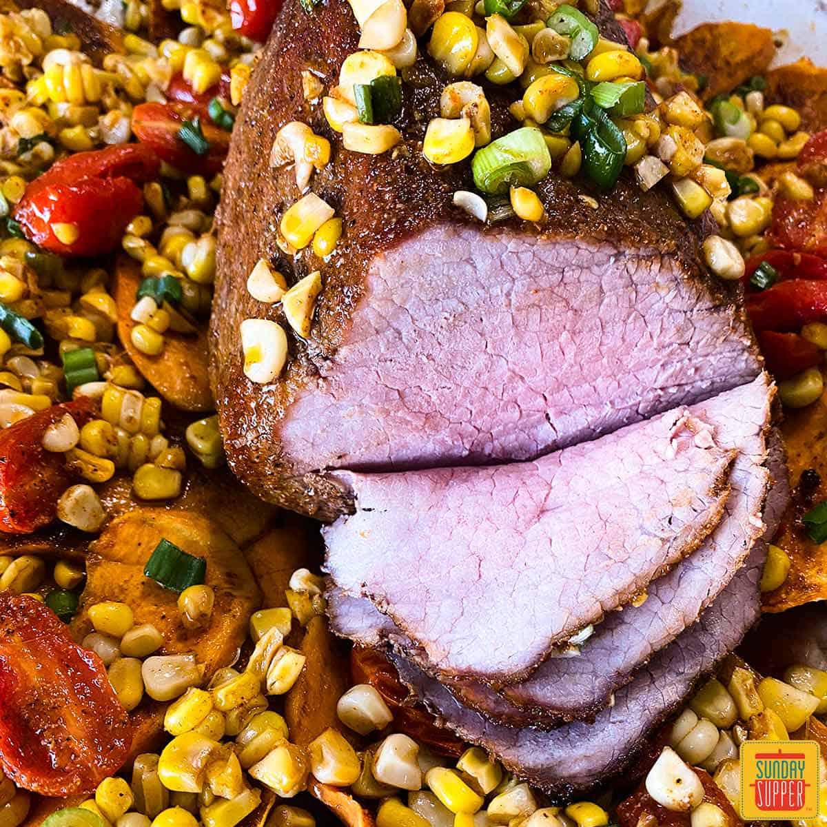 Eye of round roast with corn and tomatoes sliced