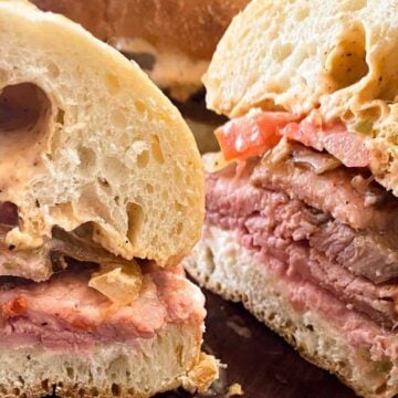 Two halves of a hot roast beef sandwich up close