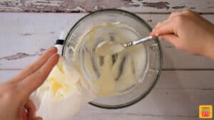 Filling a piping bag with sweet cream cheese