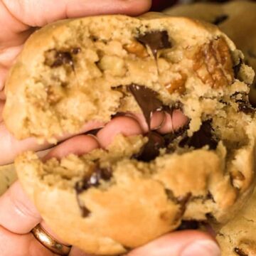 Breaking a Levain cookie in half in hands