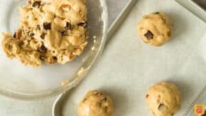 Placing levain cookies recipe dough on a baking sheet