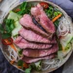 Top-down view of vietnamese steak salad with sirloin and rice noodles