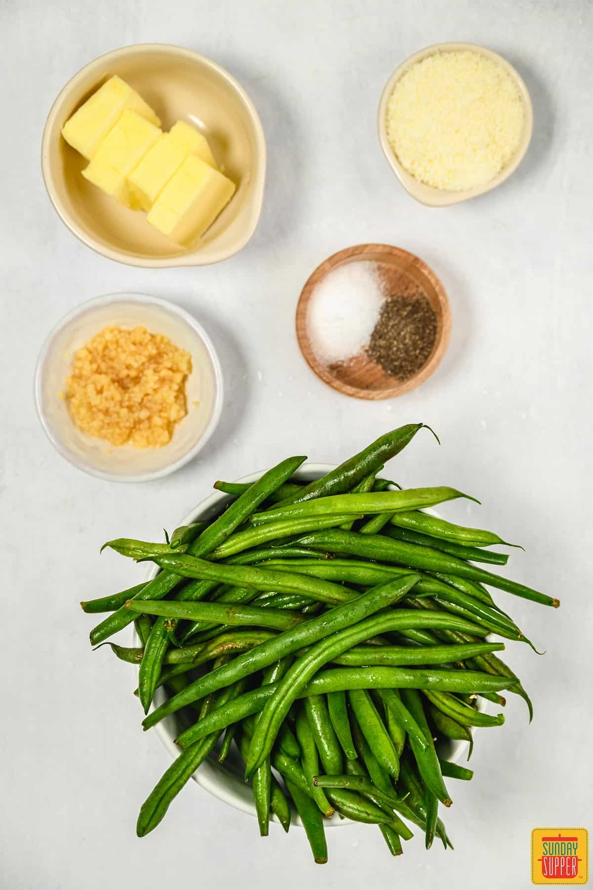 Ingredients to make Instant pot green beans on a white surface