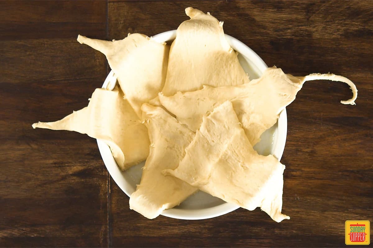 Crescent rolls layered in a white dish