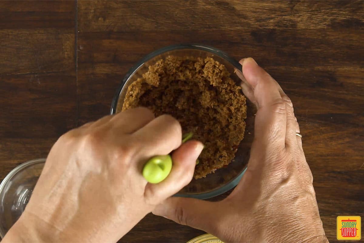 Mixing seasoning for brie in a glass dish