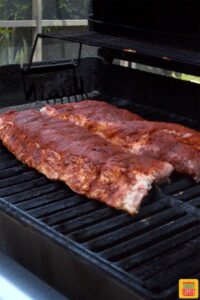 Baby back ribs cooking on the grill