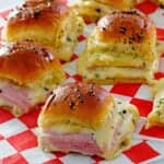 Ham and cheese sliders on red and white checked paper