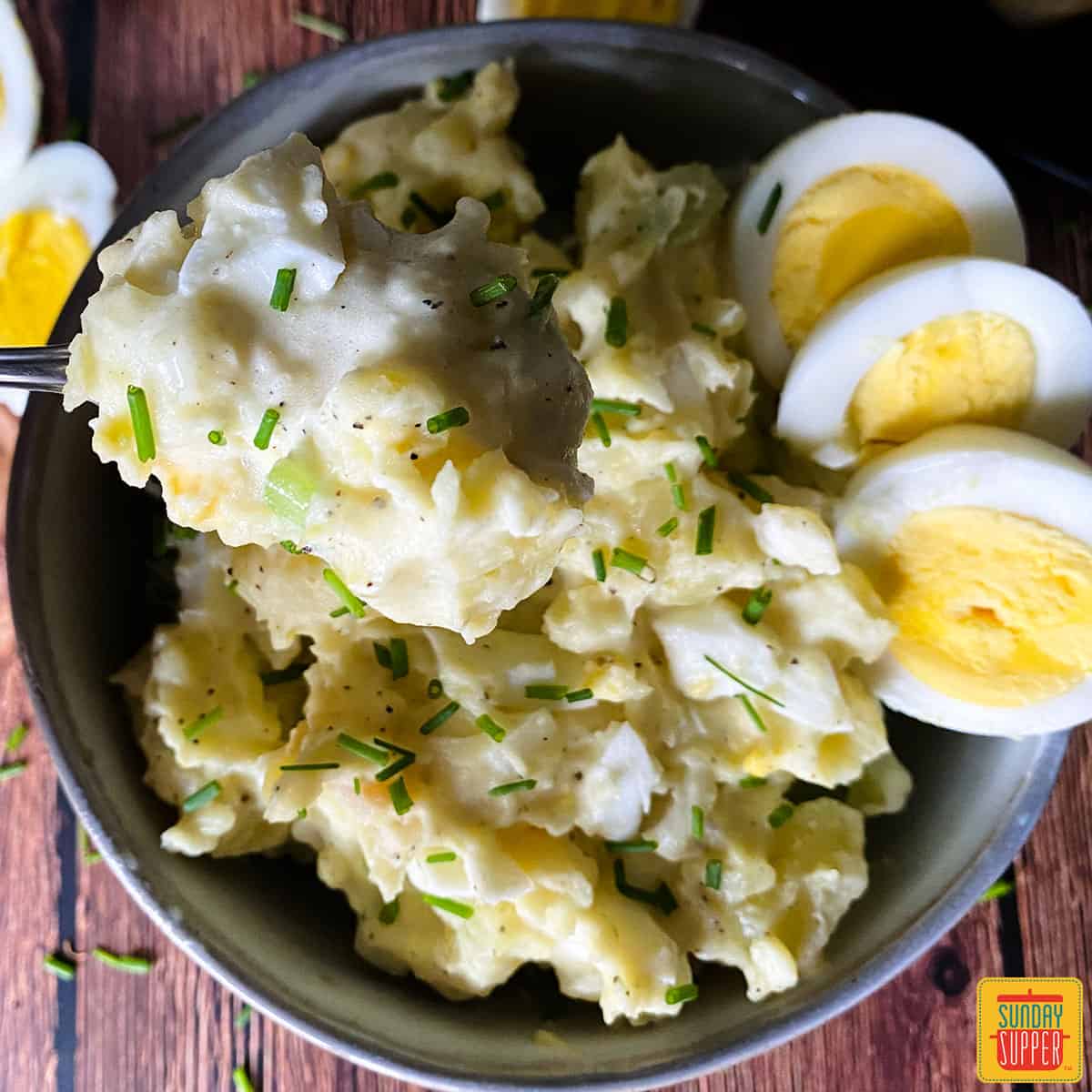 instant pot potato salad in a bowl with sliced hardboiled eggs