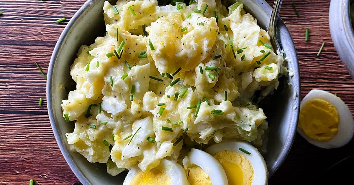 instant pot potato salad in a bowl with sliced hardboiled eggs