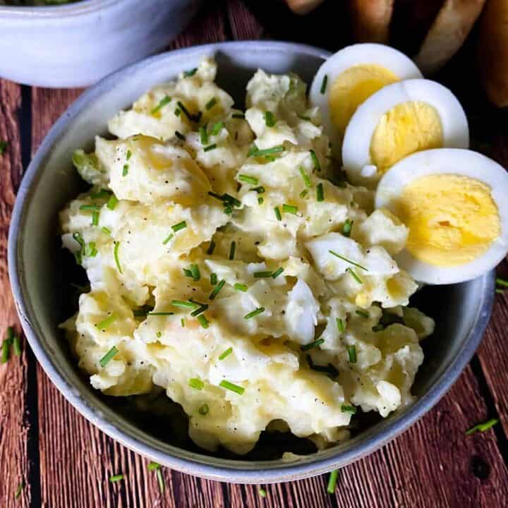 instant pot potato salad in a bowl with sliced hardboiled eggs