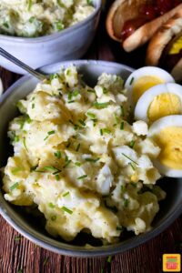 Close up of creamy instant pot potato salad in a bowl with hard boiled eggs
