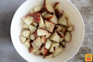 Chopped red potatoes in a white bowl