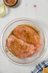 Marinating chicken in a bowl