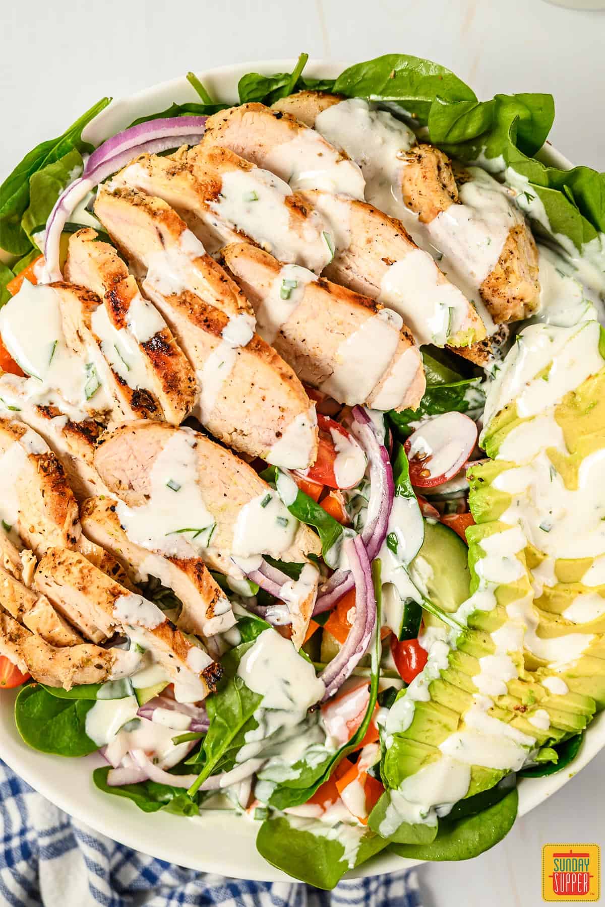 Close up of grilled chicken salad with buttermilk ranch dressing