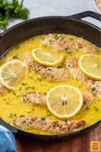 lemon chicken in pan with sauce