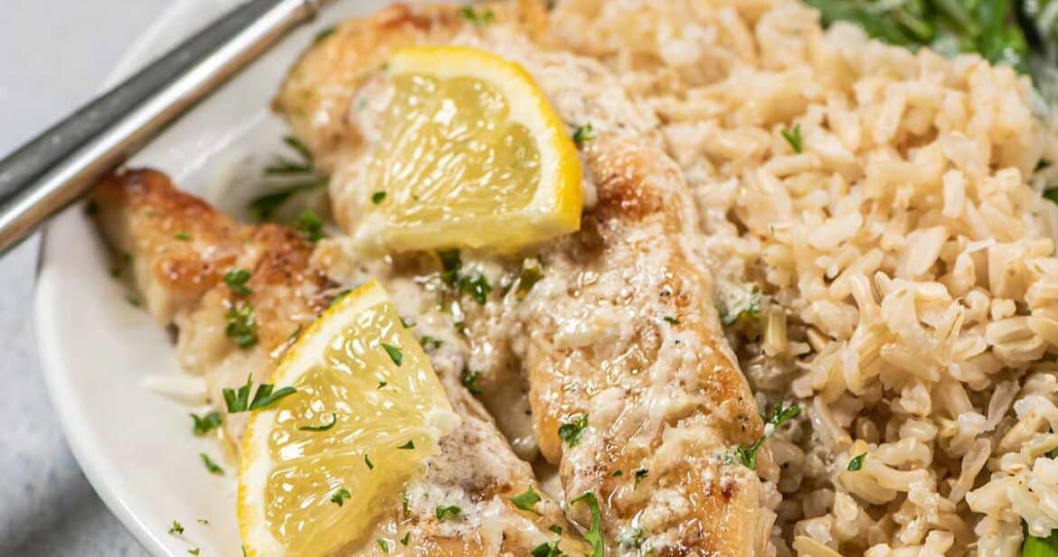 lemon chicken tenders on plate with rice and veggies