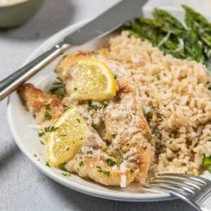 lemon chicken tenders on plate with rice and veggies