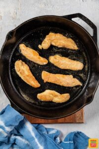 chicken tenders cooking in pan